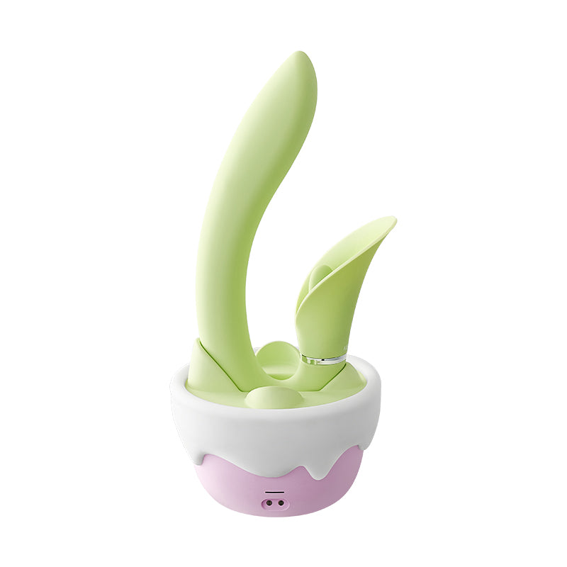 Front view of the green leaf wand in its pink and white flower-pot base on white