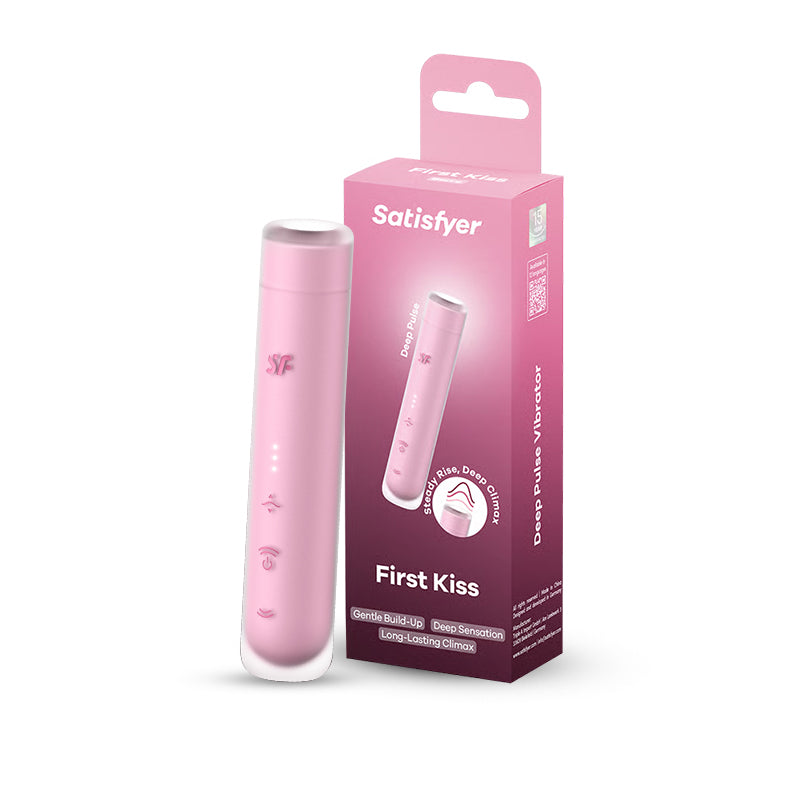 Pink Satisfyer First Kiss vibrator displayed upright beside its branded retail box.
