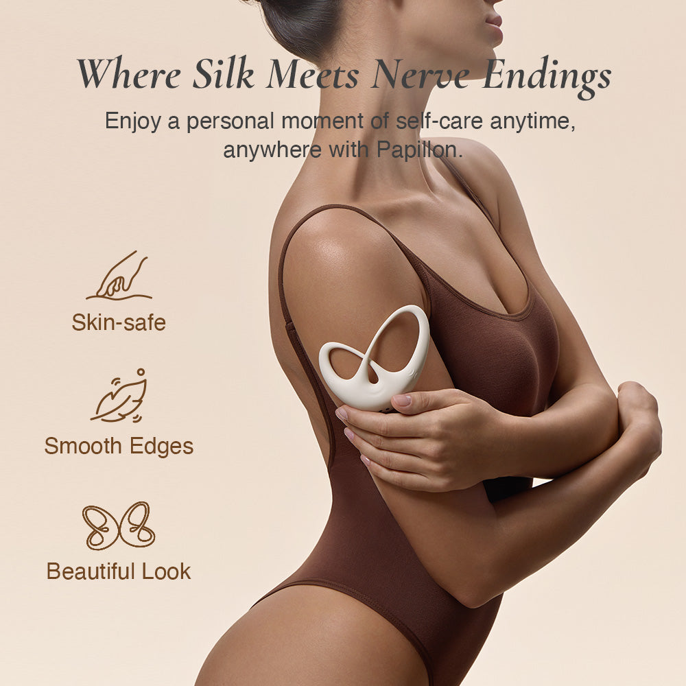 Close-up of model’s side torso in brown bodysuit holding the vibrator, highlighting its smooth silicone edges.