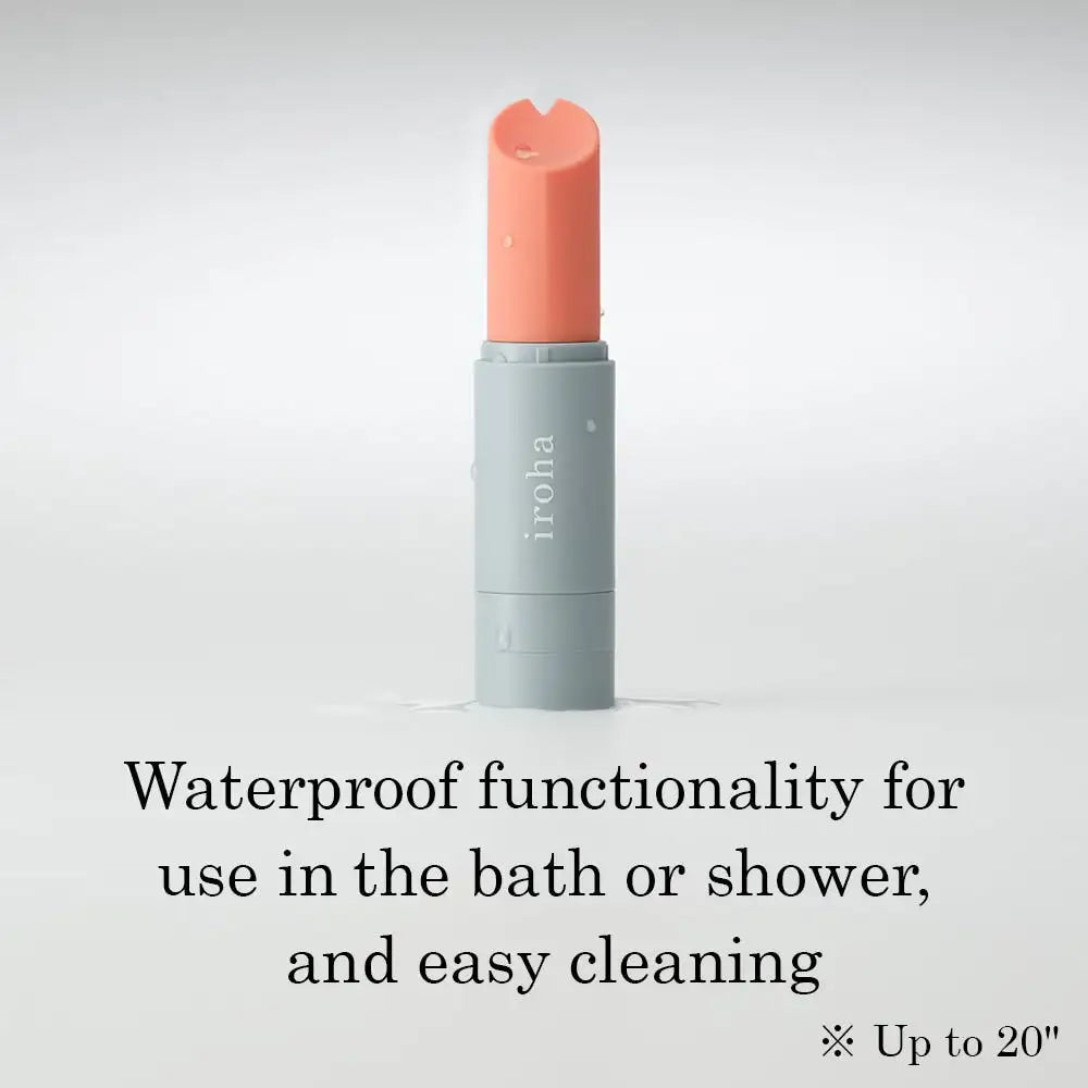 Cosmetic stick with coral cap and gray body on a light gray background