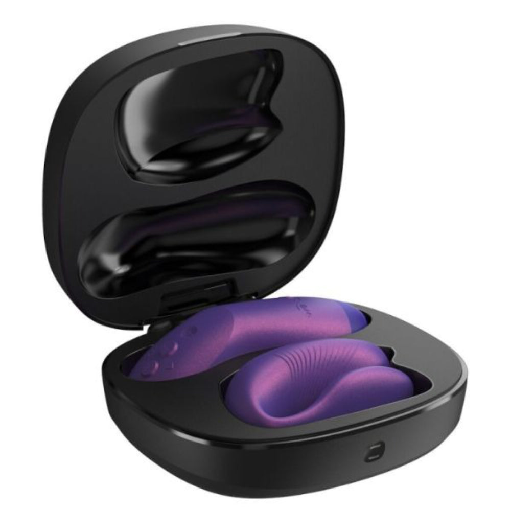 Open charging case revealing the purple We-Vibe Chorus Pro vibrator and remote inside.