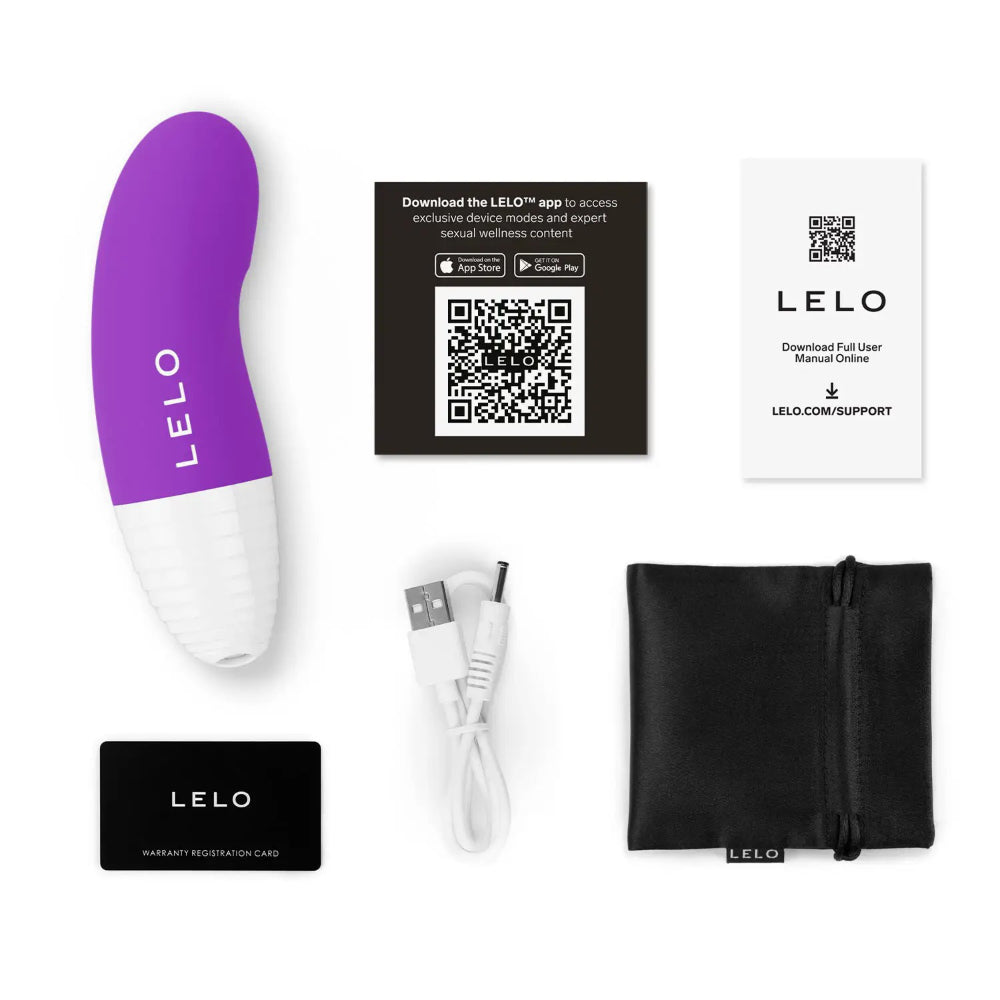 Purple clitoral vibrator shown with charging cable, warranty card, manual, and discreet storage pouch.