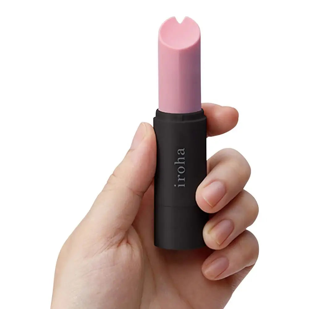 Hand holding lipstick-style vibrator, showing size, grip, and portability