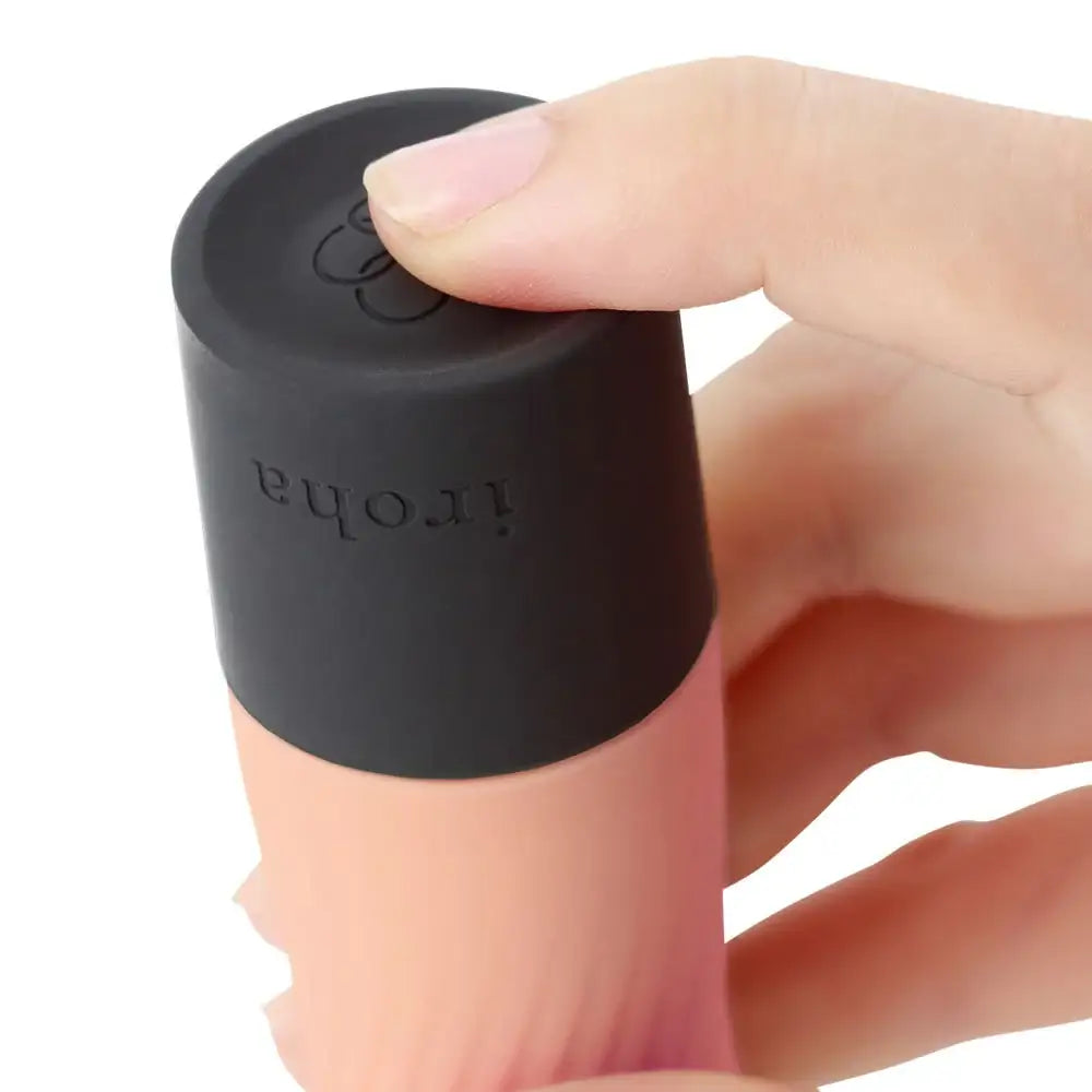 Hand holding a black silicone coffee sleeve with 'iroha' branding on a white background
