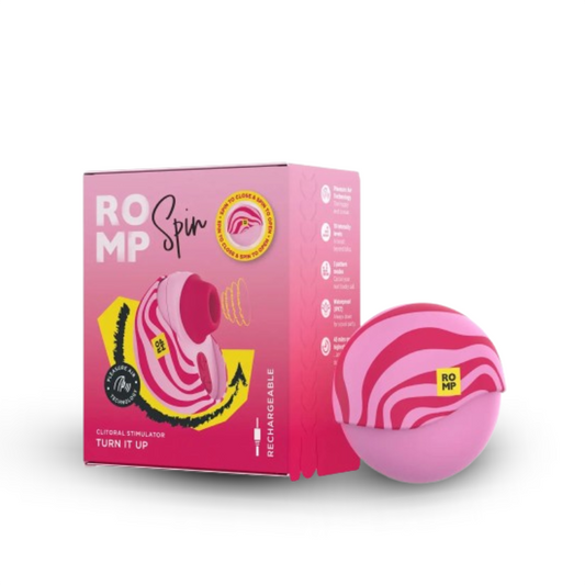 ROMP Spin clitoral stimulator shown beside its pink retail packaging.